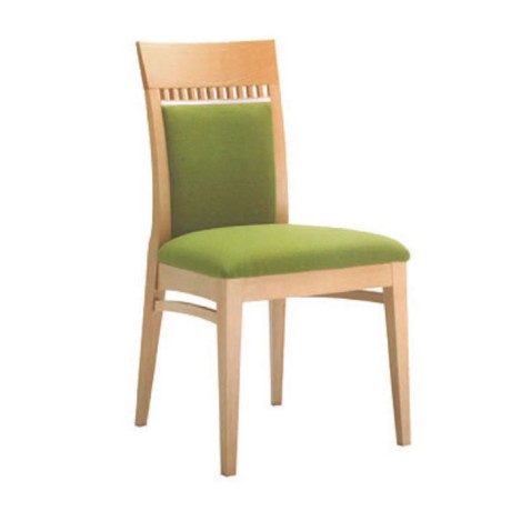 Modern chair made of light wood upholstered in pistachio-colored fabric